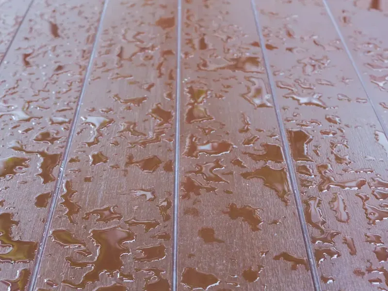 Beads of water on a laminate floor where a hidden leak came through