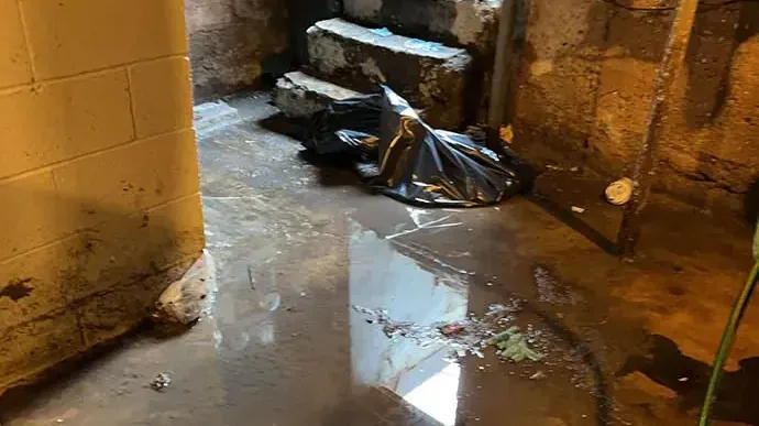 Storm water standing on a basement floor beside the stairs